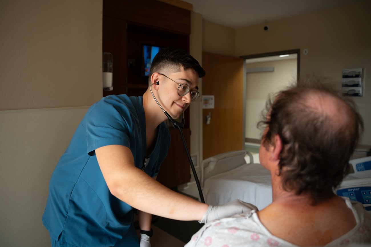 A nurse listens to the heartbeat of a patient