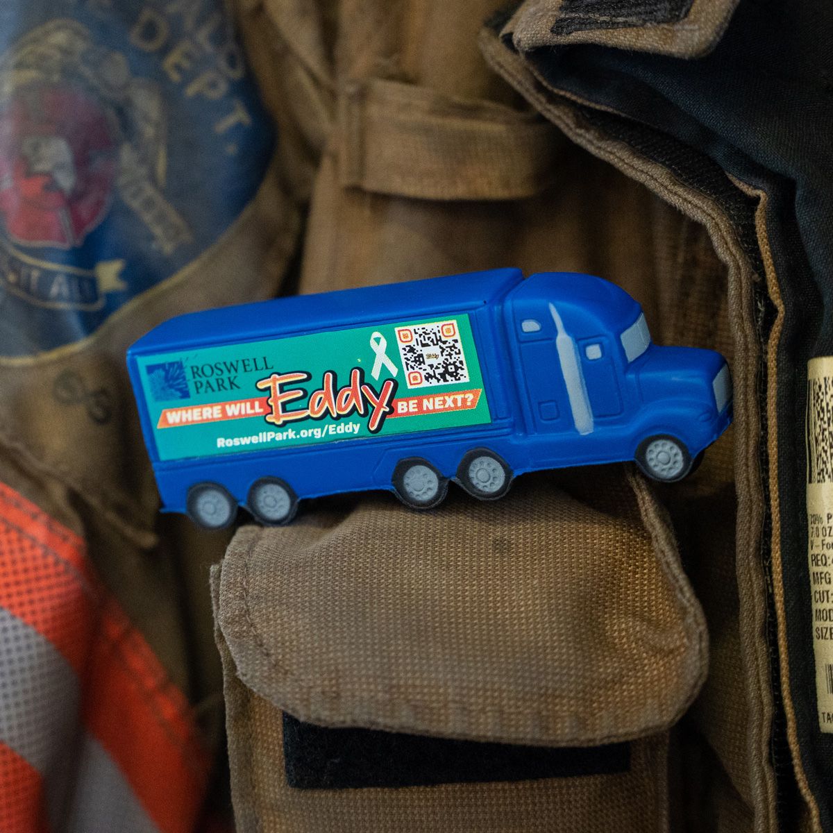 Model of the EDDY truck sitting on a firefighter's jacket