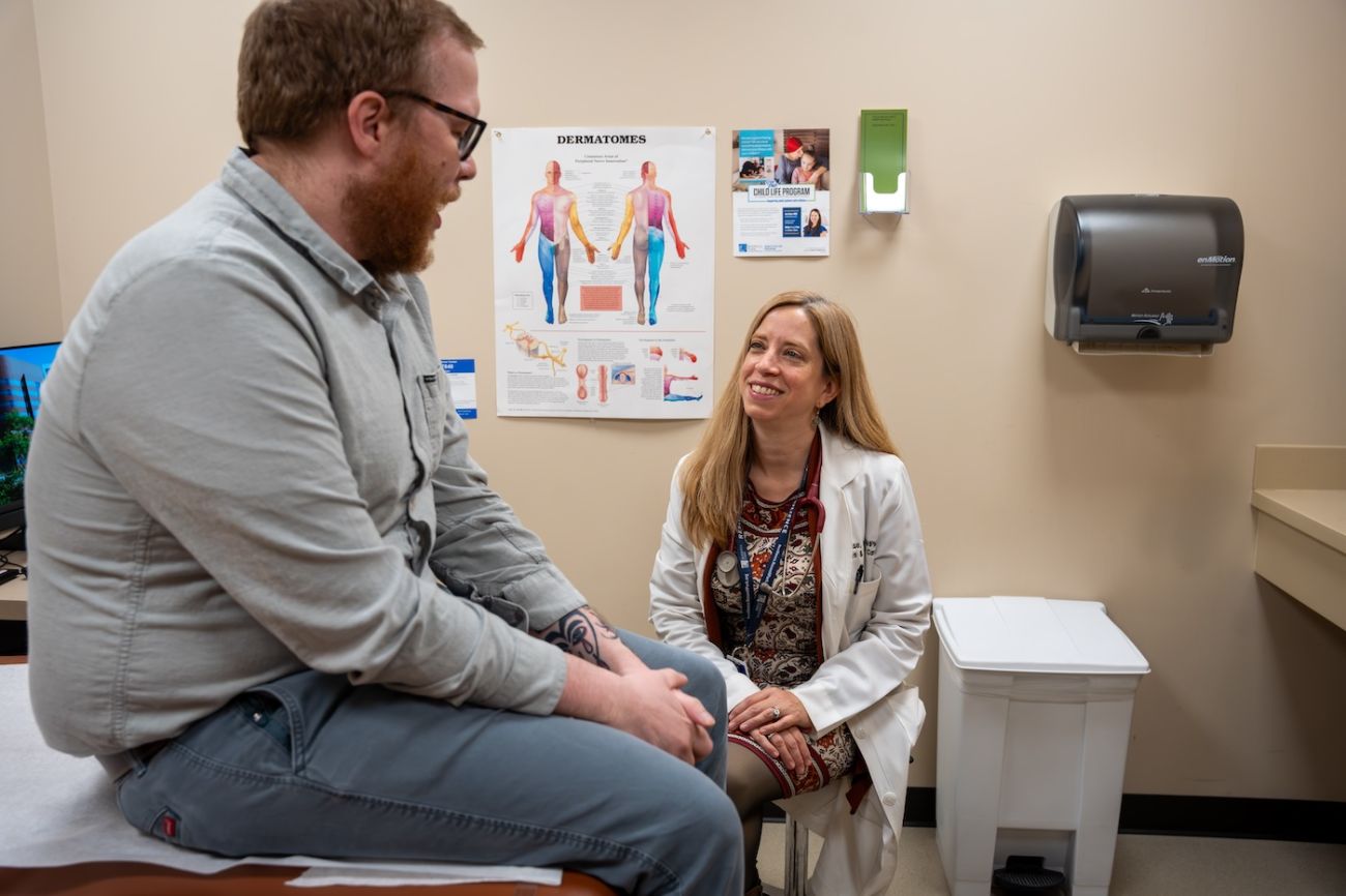 Dr. Amy Case speaks with a male patient in clinic