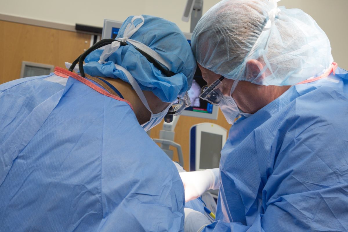 Doctors in scrubs performing brain surgery