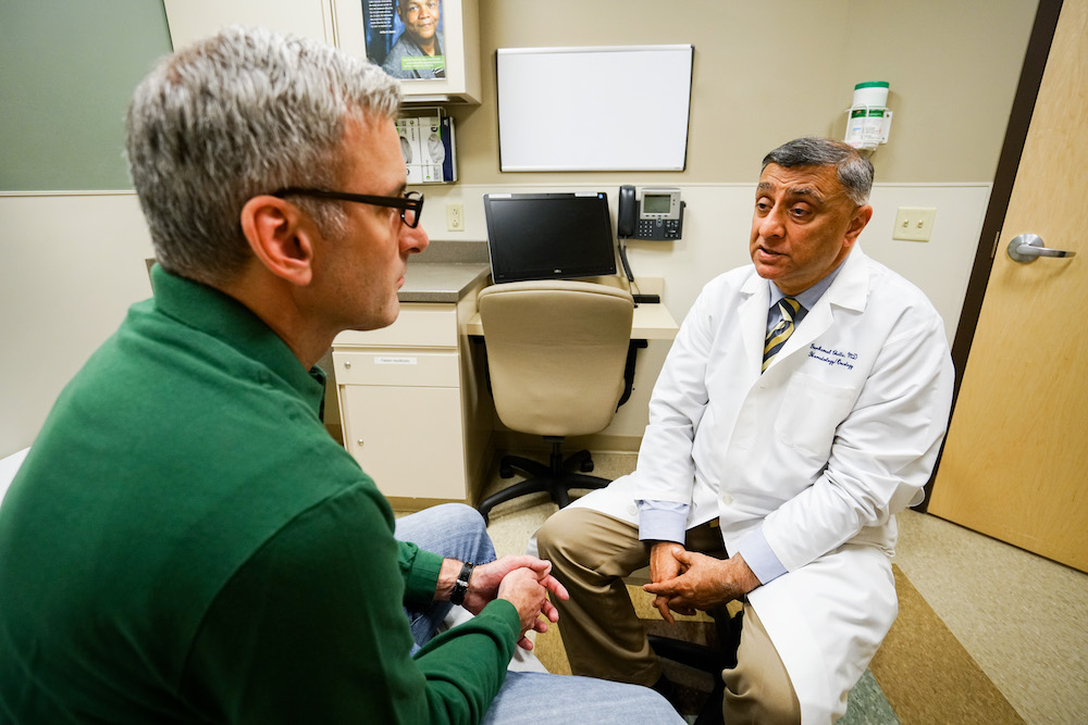 Dr. Chatta with patient in clinic