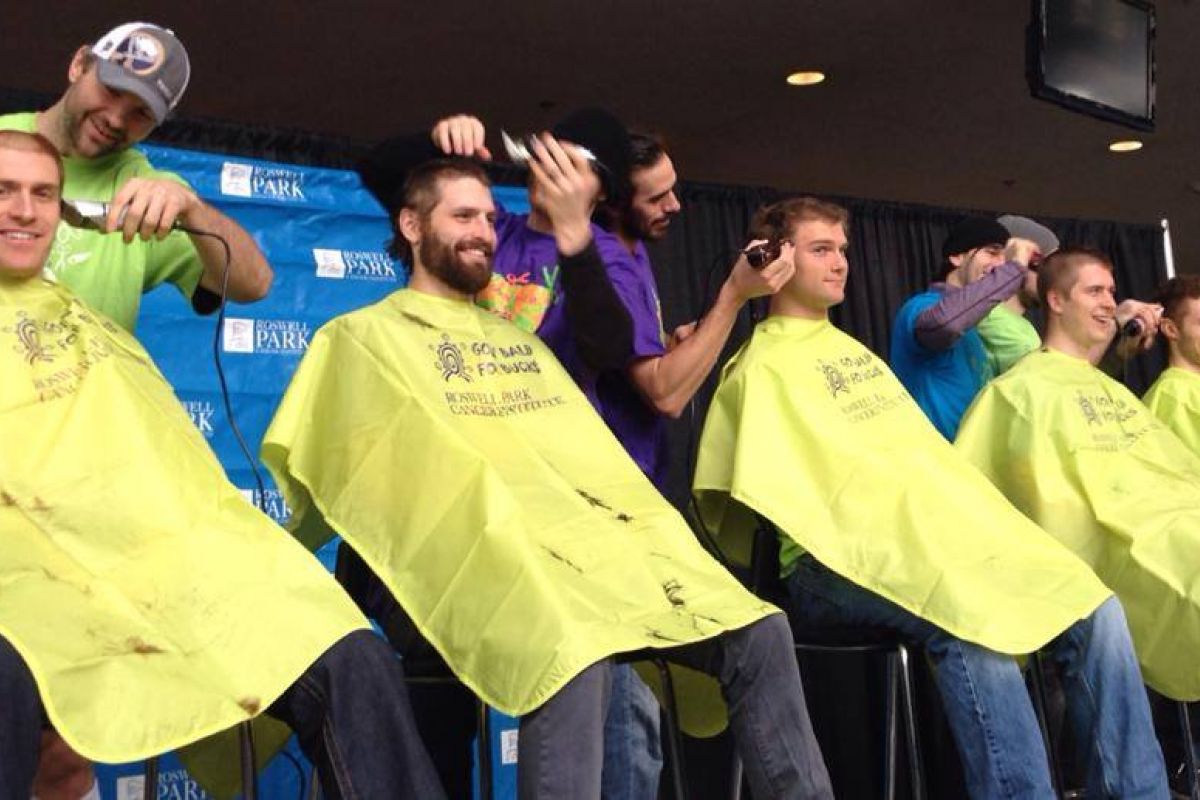 Participants getting their heads shaved at Bald for Bucks