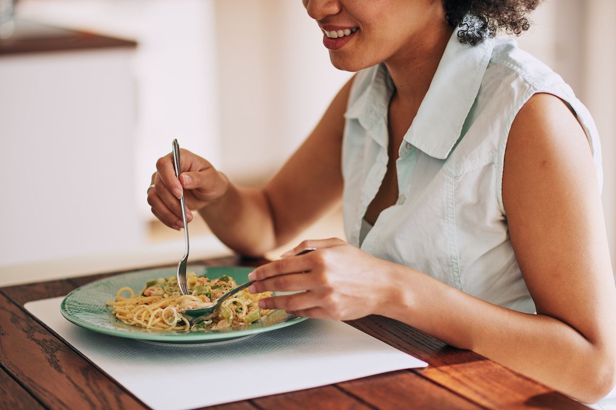 Woman eating pasta