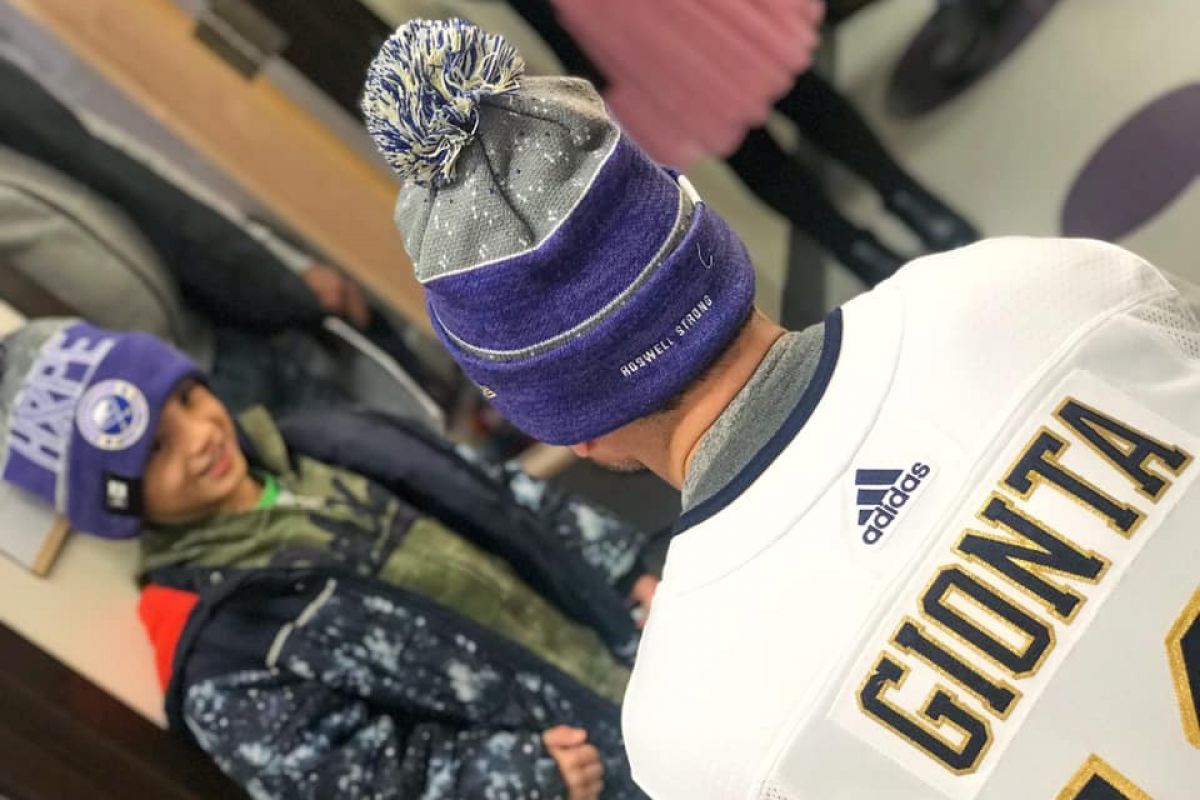 Buffalo Sabres alumnus Brian Gionta gives out caps