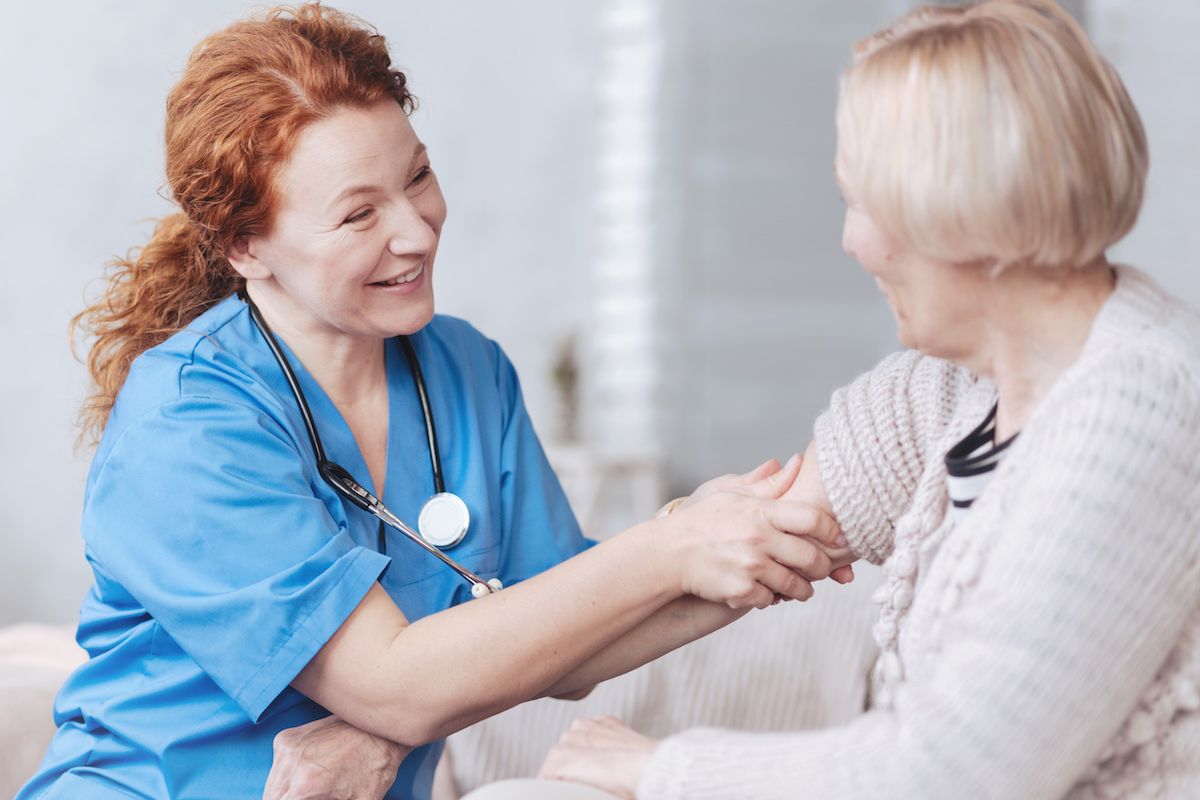 Nurse comforts elderly patient