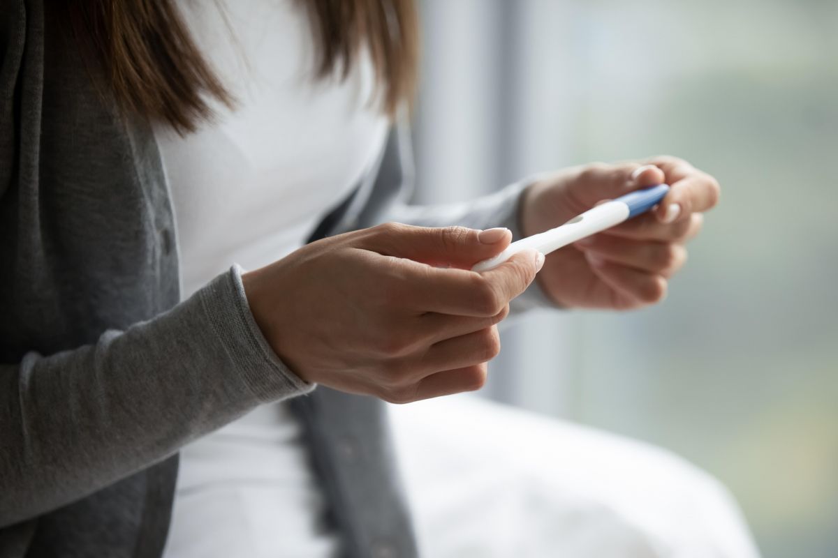 Woman holding a pregnancy test