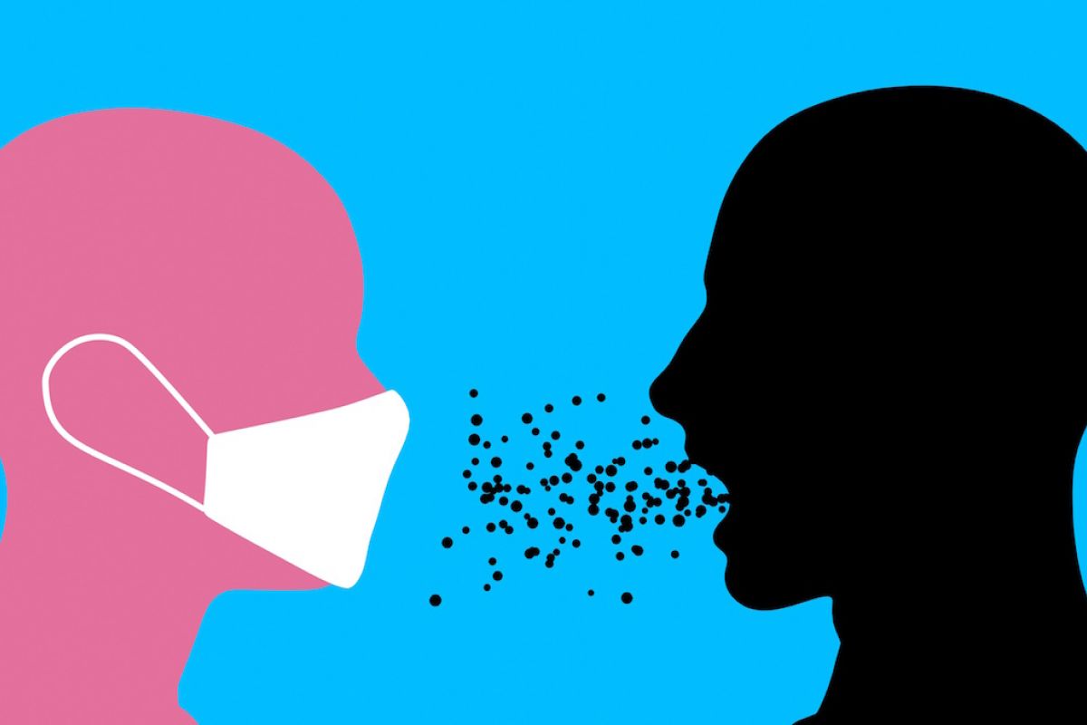 Image of a person wearing a mask while another person who is not wearing a mask spews germs into the air