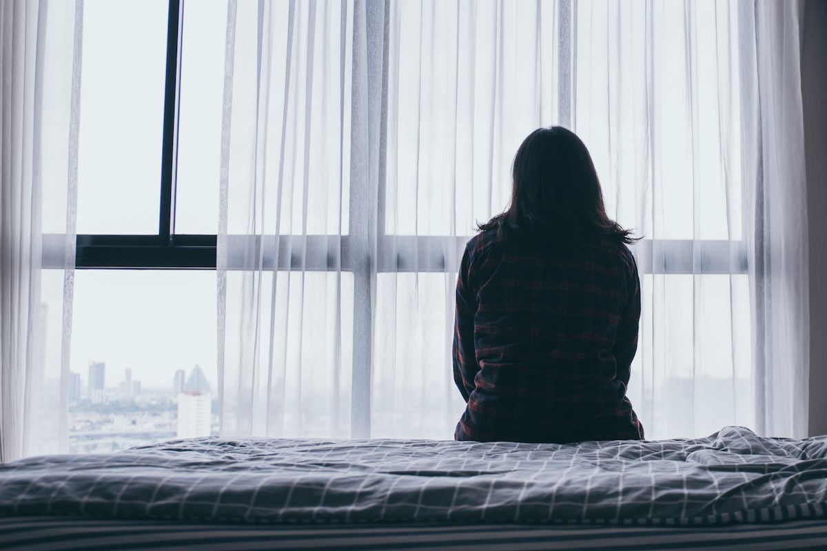 Image of woman looking out window