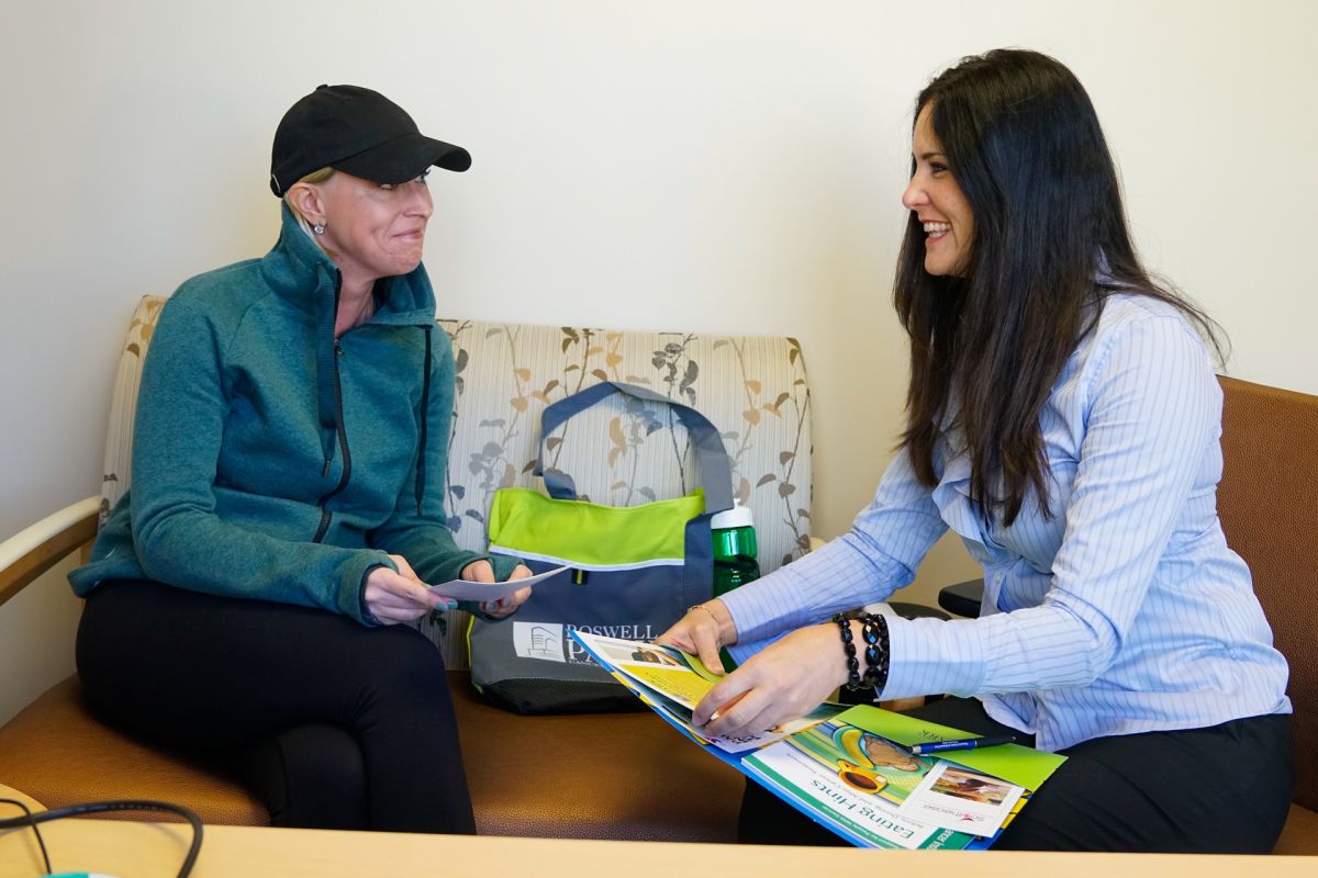 Amy Lesakowski assists a patient with chemotherapy orientation