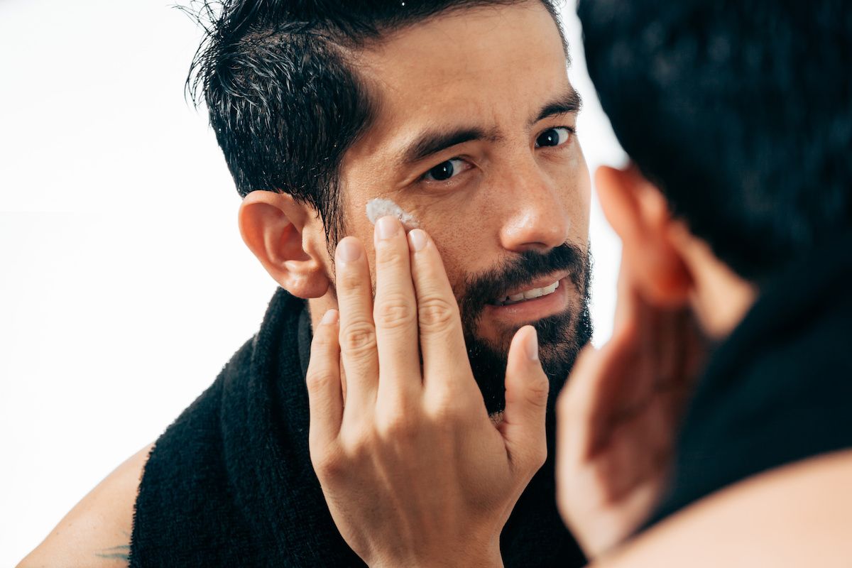 Person applying moisturizer to their face