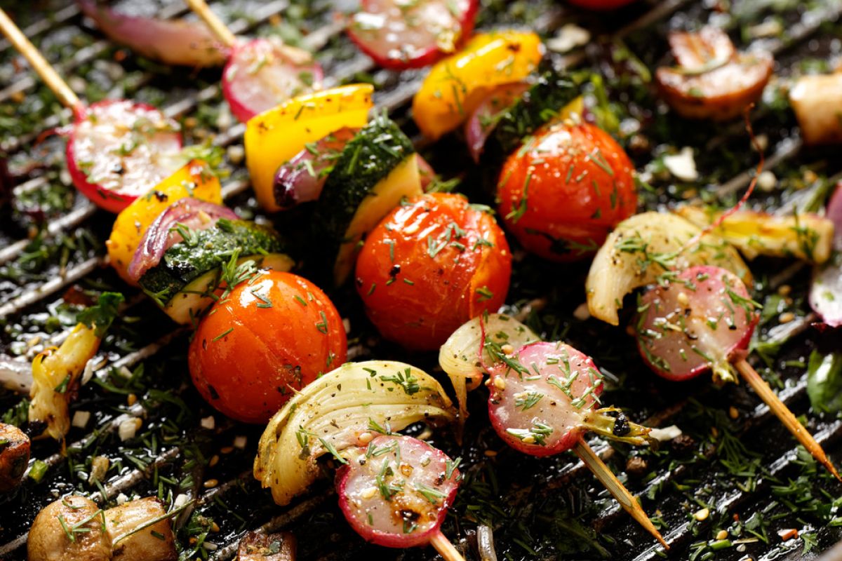 Vegetable shishkebabs cooking on a grill