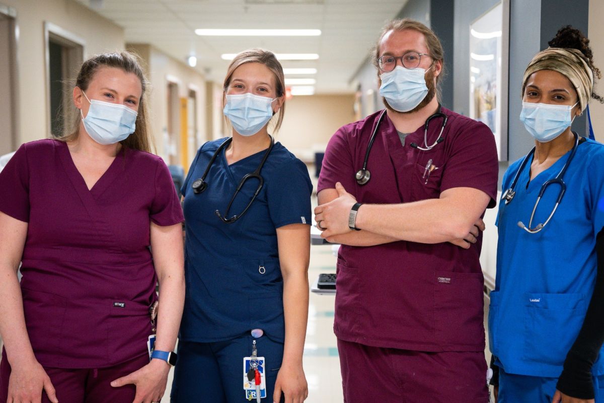 Group of nurses stand next to each other