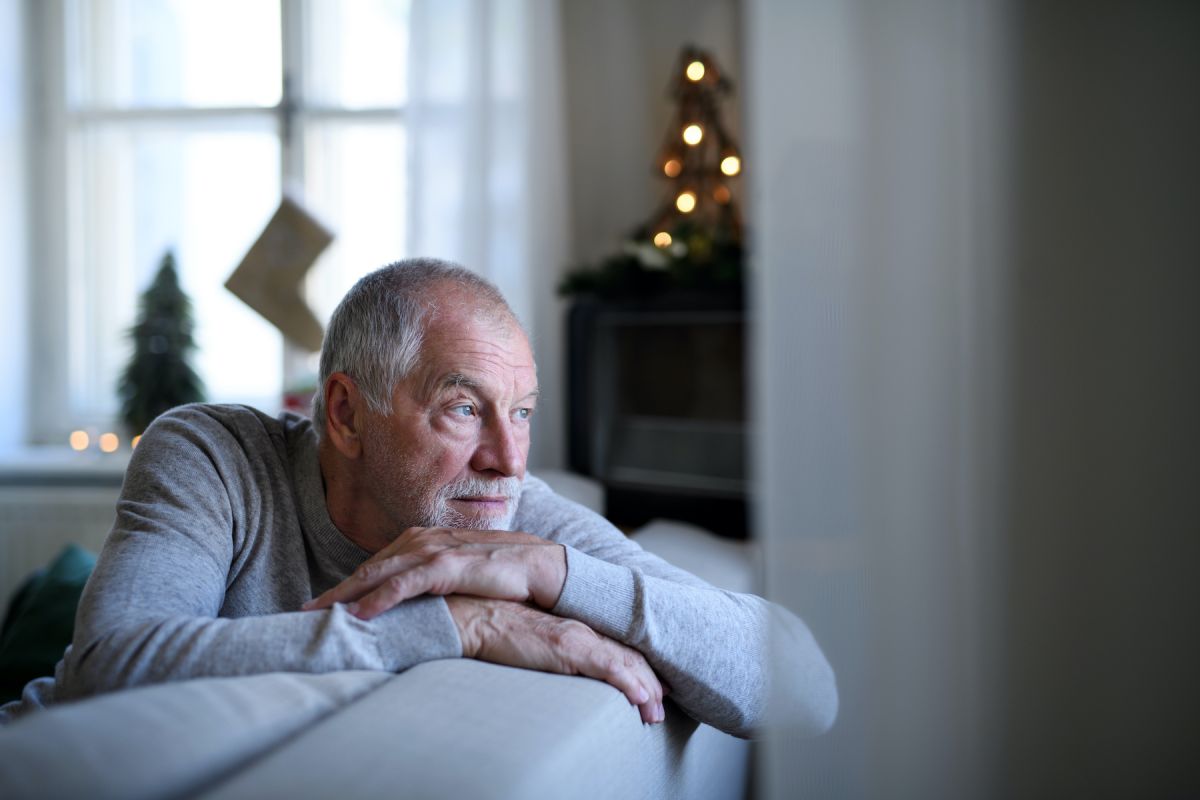 Man looking sad out the window 