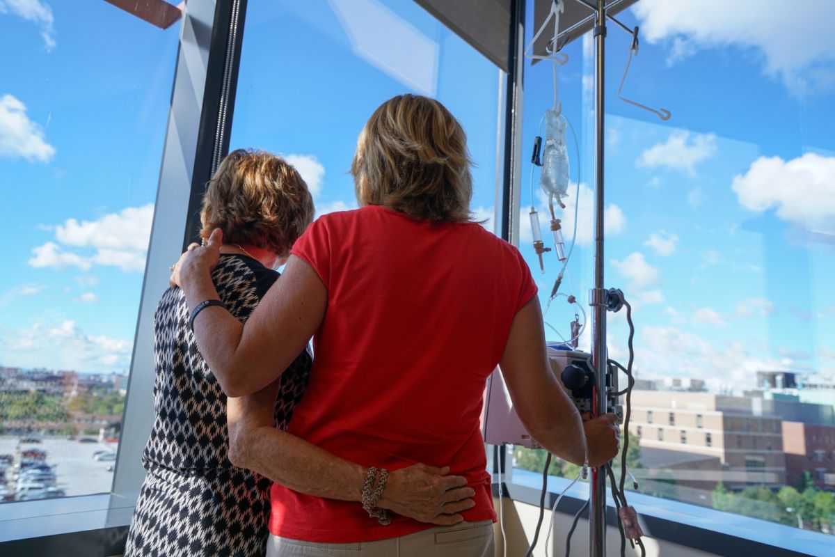 Two women in chemo look out the window