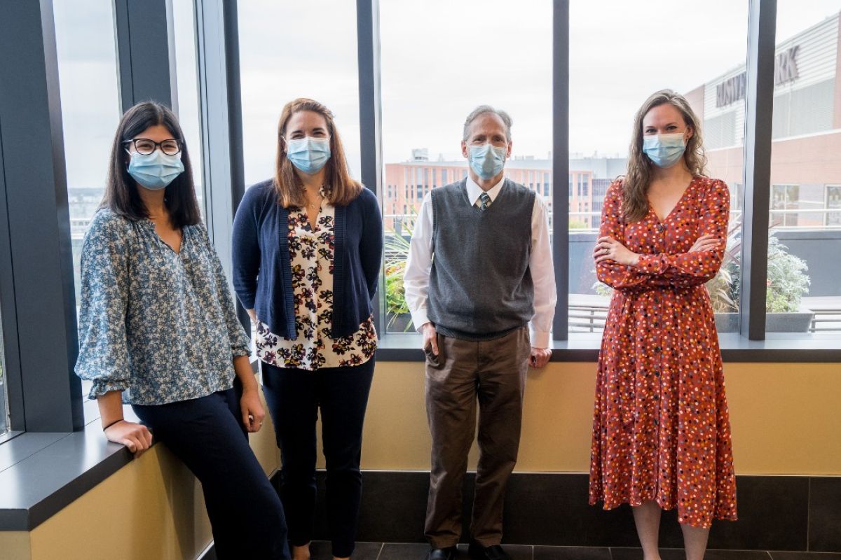 Members of the Cancer Genetics team stand near a window. 