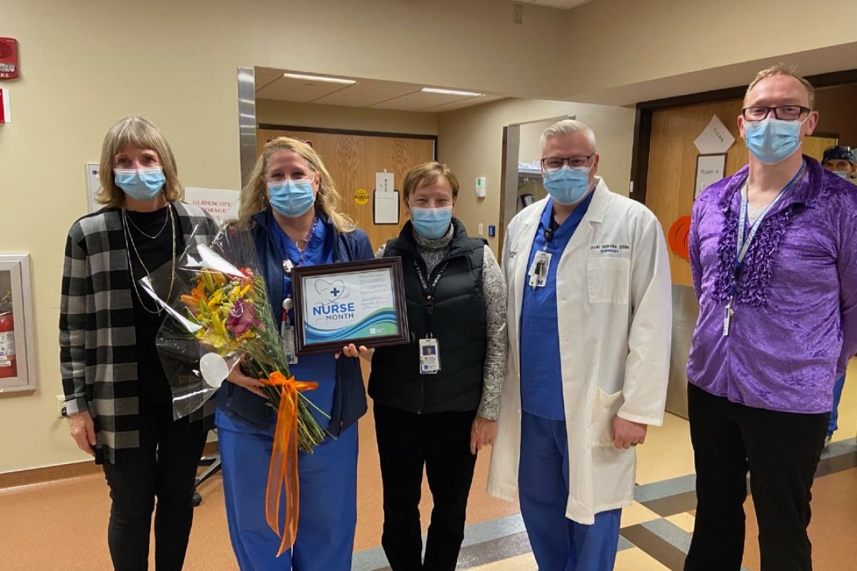 Dr. Candace S. Johnson, left, presents Kelley Watson with flowers and a certifcate for being named Nurse of the Month for November.