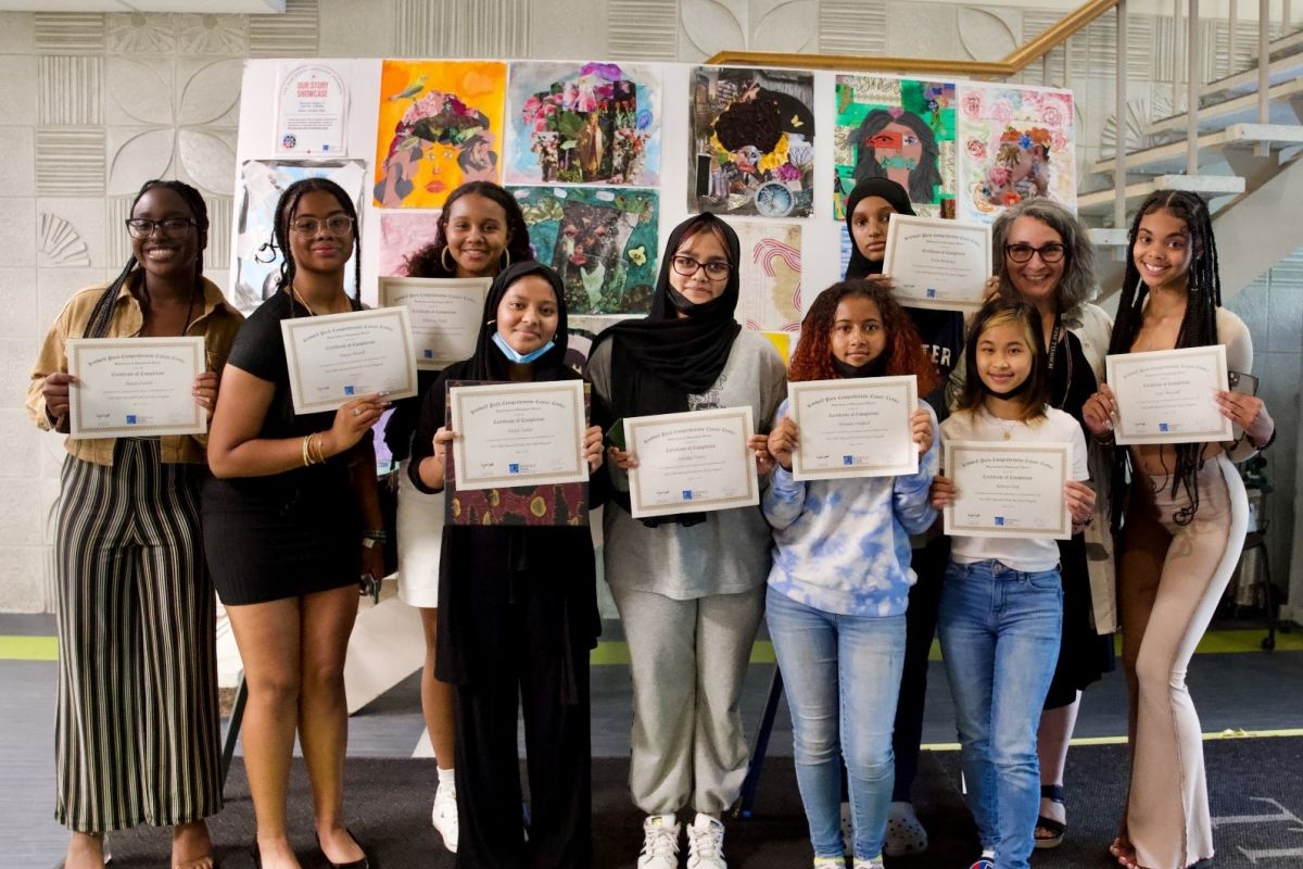 group of students posing near artwork