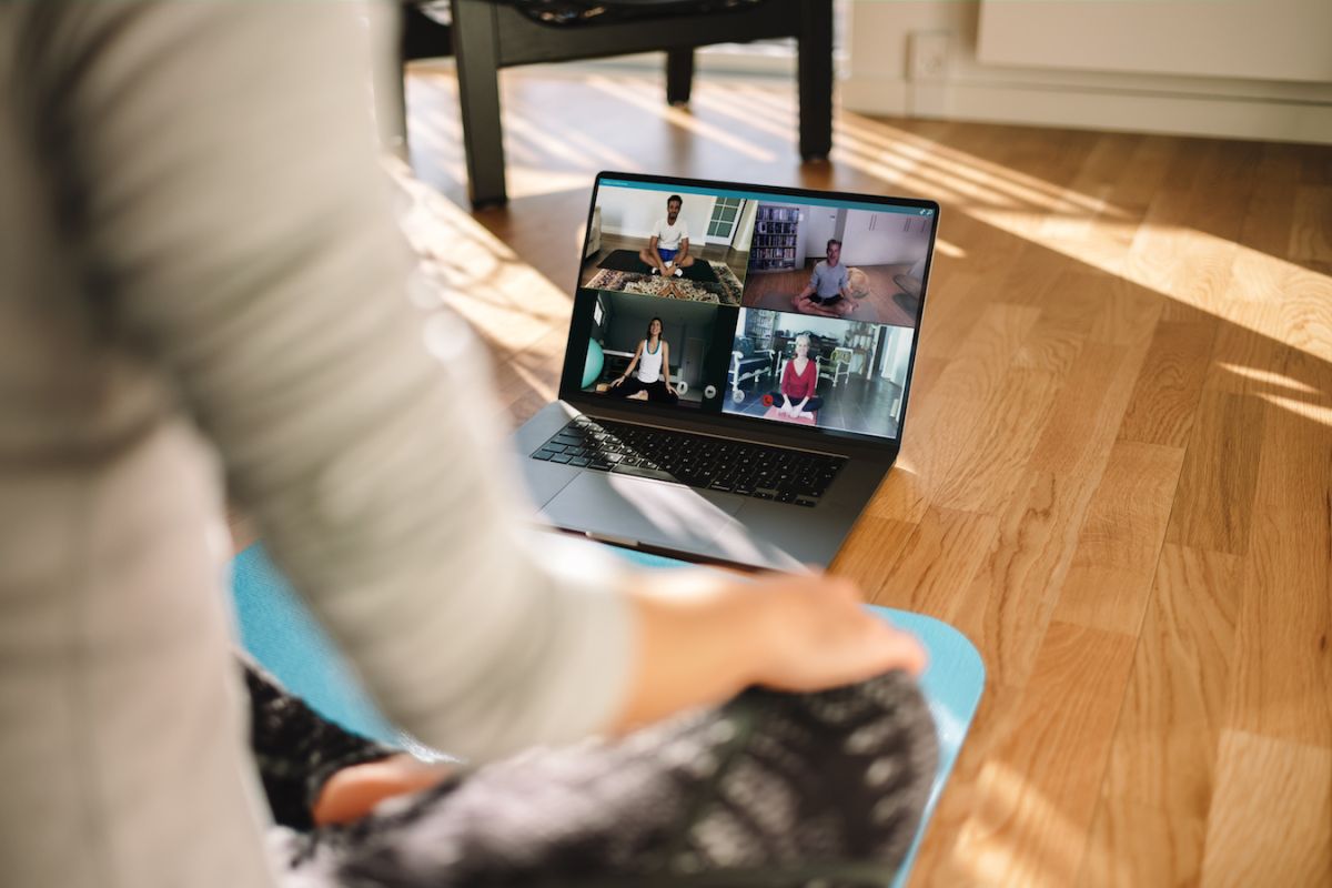 Virtual yoga and mindfulness session on a computer - stock 