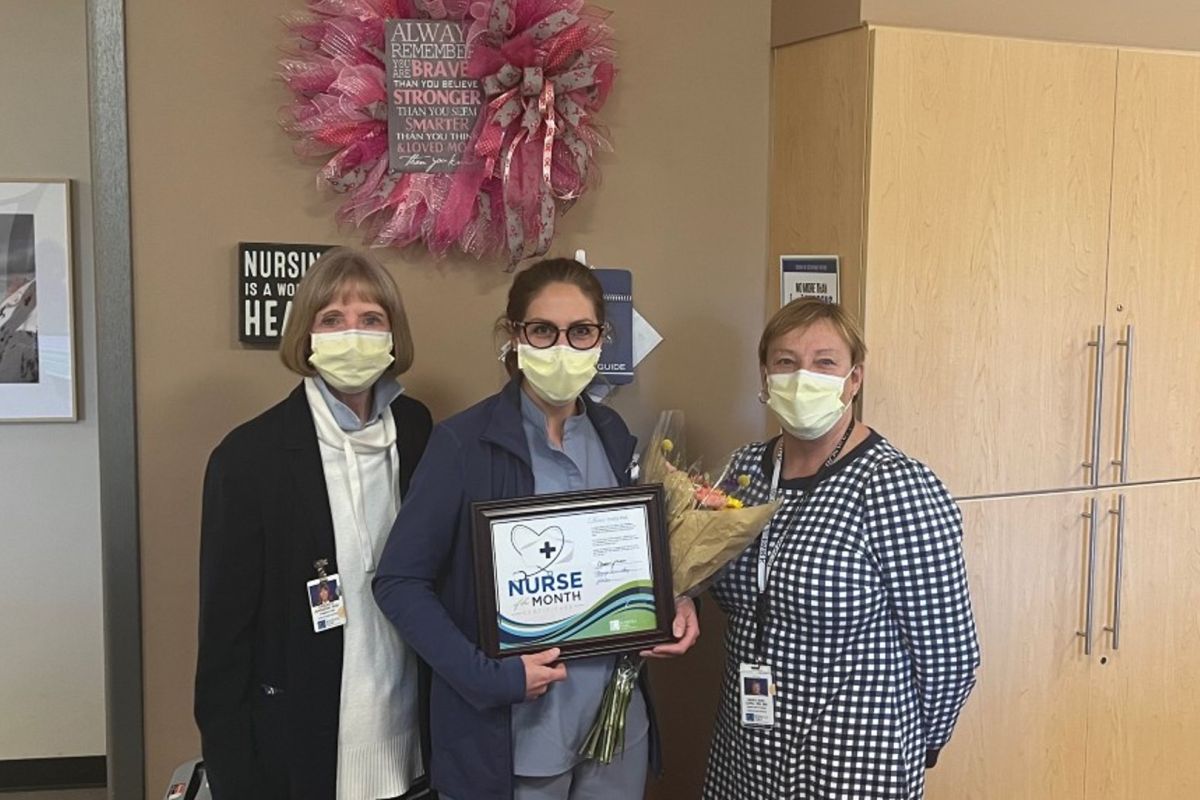 Shelby Max, center, holds a plaque presented to her from Dr. Candace Johnson, left, and Mary Anne Long, right.