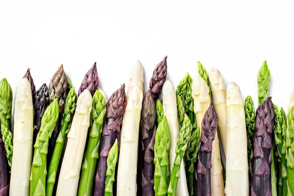 A handful of green, white and purple asparagus
