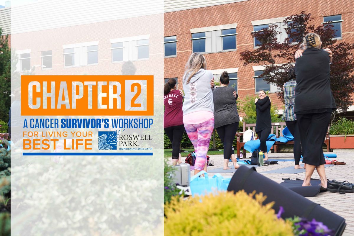 group of people doing yoga in the park, with a banner for Chapter 2 event