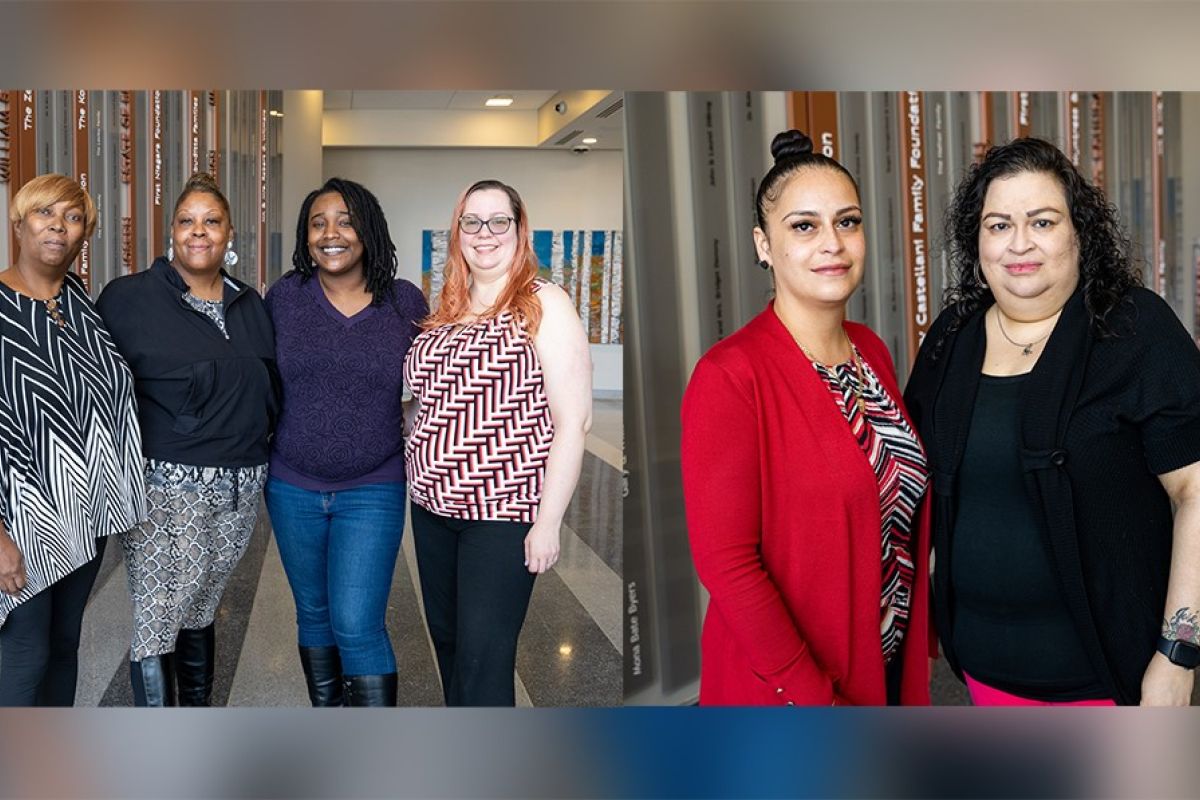 Two groups of women: the first is a group of four women standing in a lobby, the second is a group of two women standing together. 