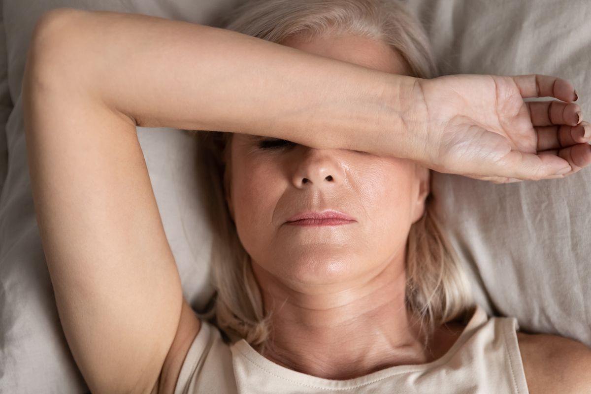 Woman in bed not feeling well