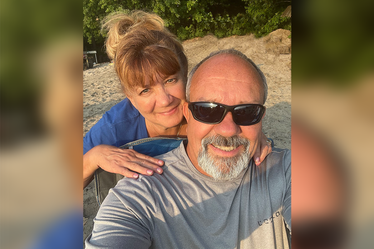 Patient Jim and his wife Barb Abbatoy pose together a beach