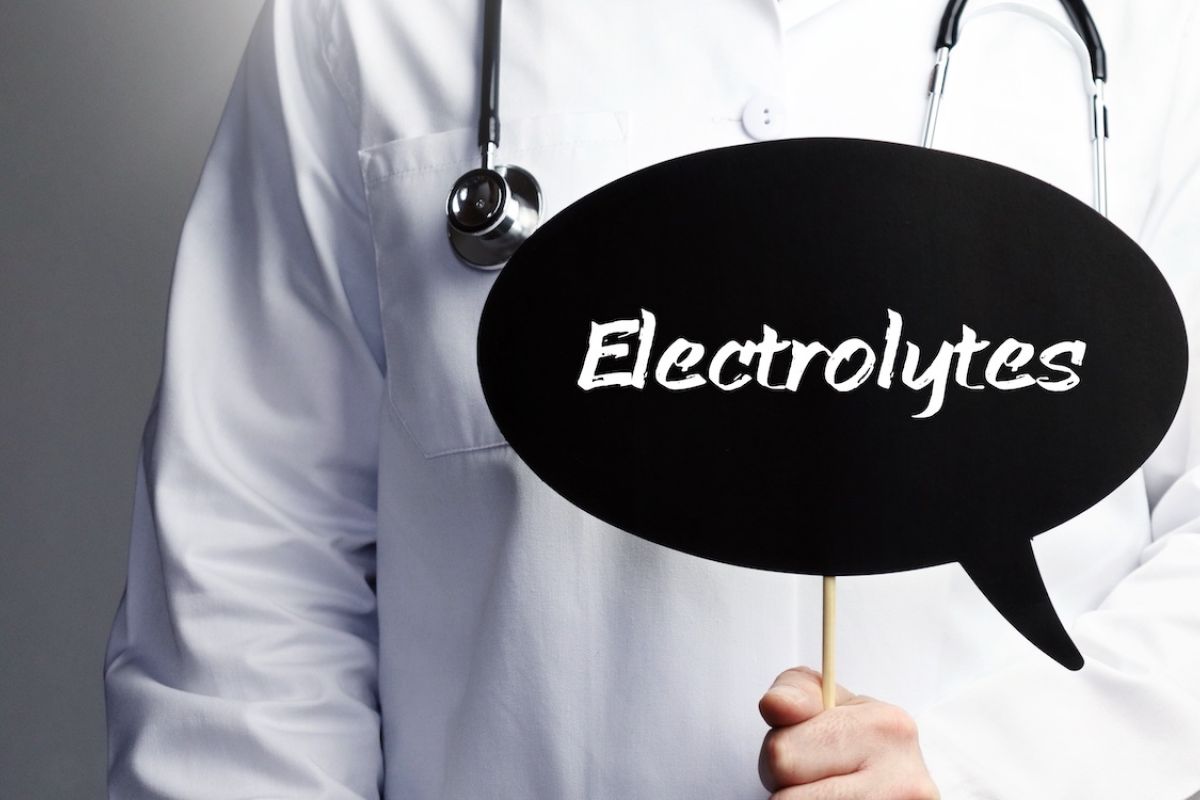 Physician holding sign that reads electrolytes