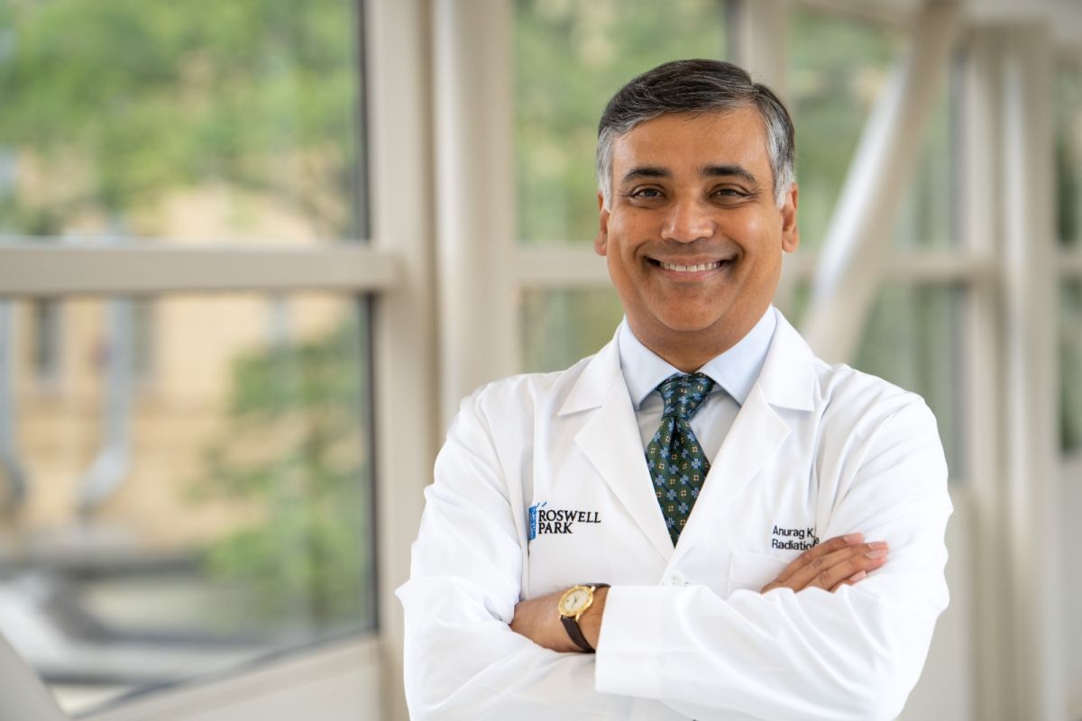 doctor stands cross-armed in a white coat