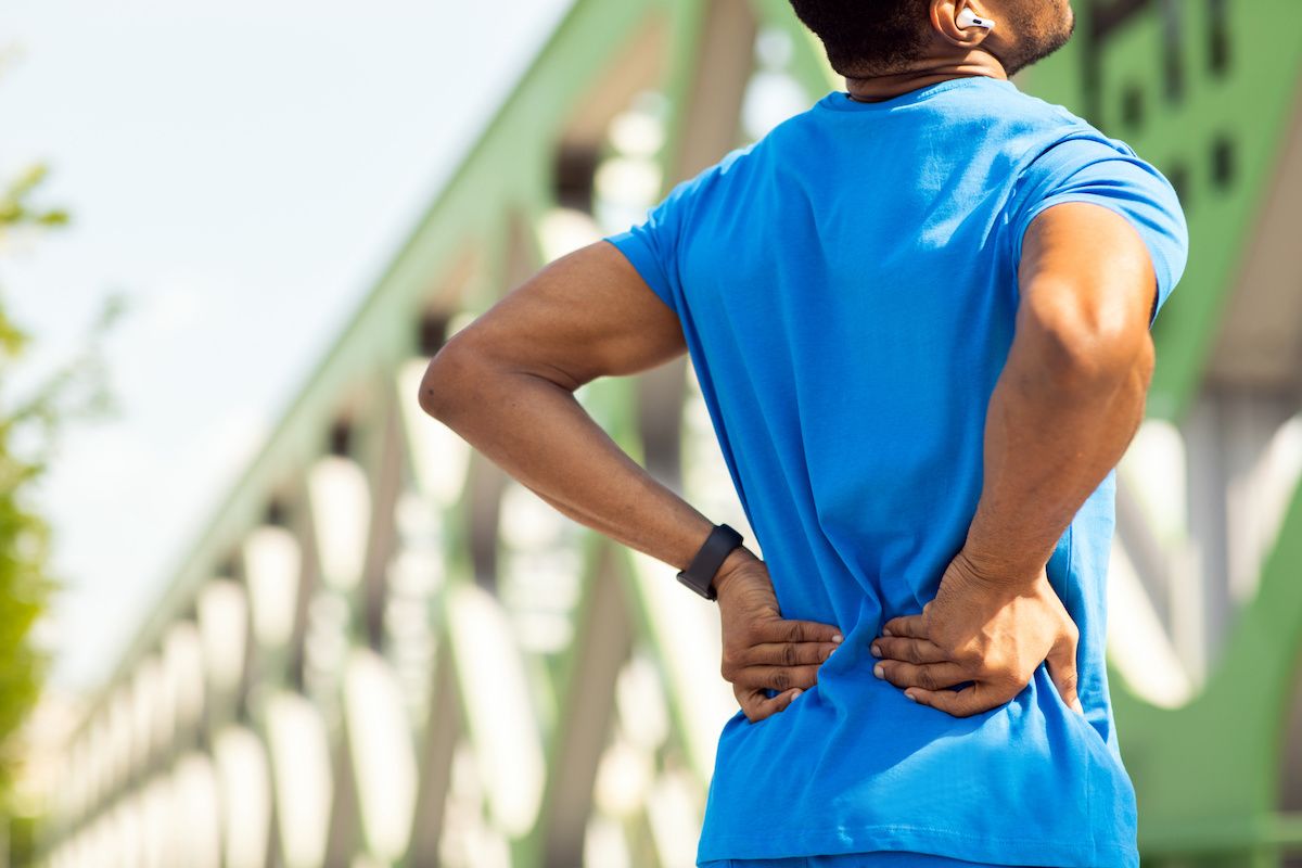 Man holding his lower back in pain