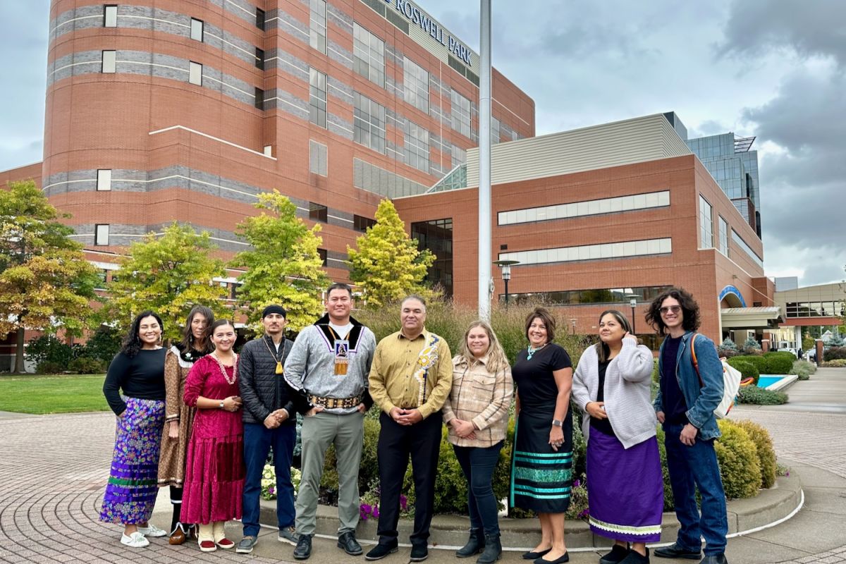 Dept of Indigenous Cancer Health poses in front of the flagpole in Kaminski Park