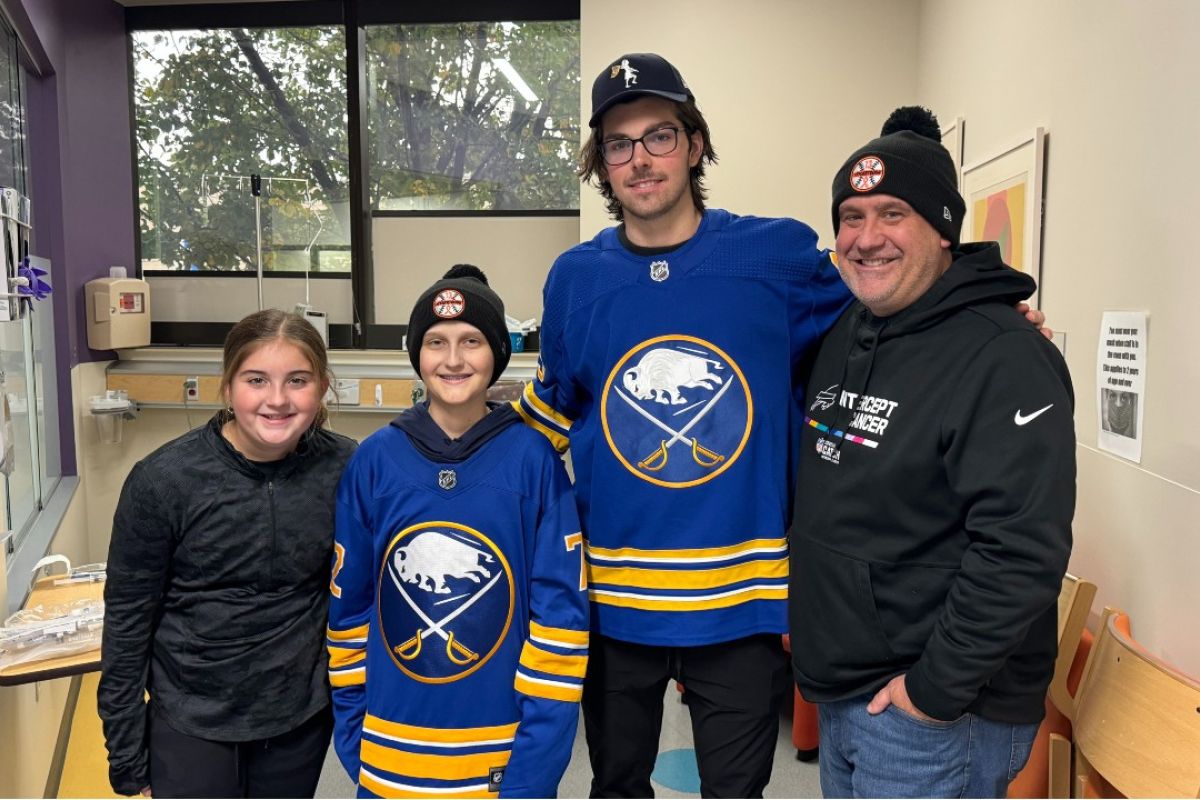 Tyler Kruse, second from left, stands with his sister, Taylor, Buffalo Sabres defenseman Owen Power, and father Mike Kruse.