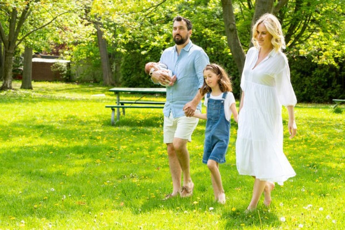 Cassandra, a Roswell Park patient with brain cancer, walking in a park with her family.