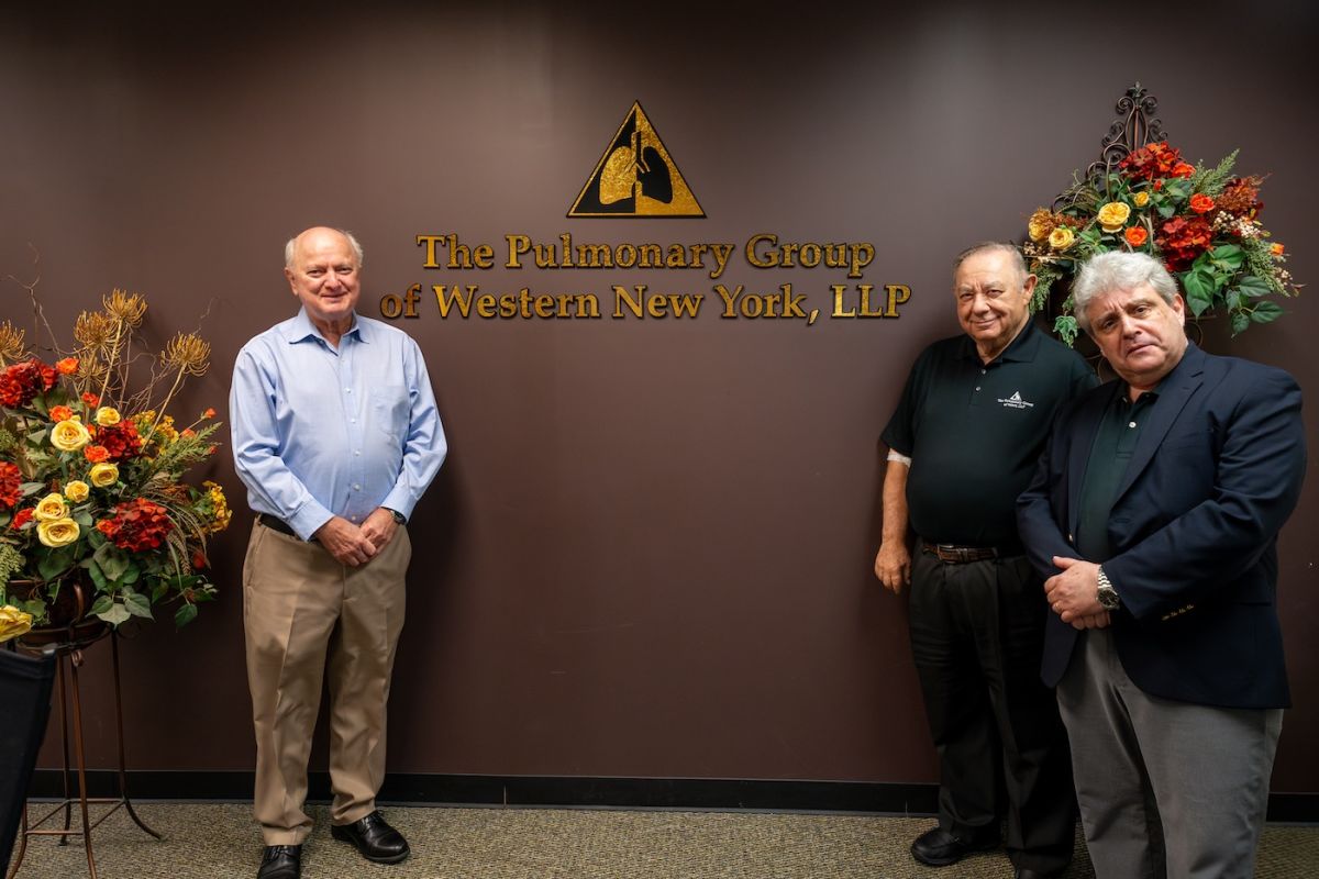 3 doctors at the Care Network College Parkway location pose outside the building at the opening
