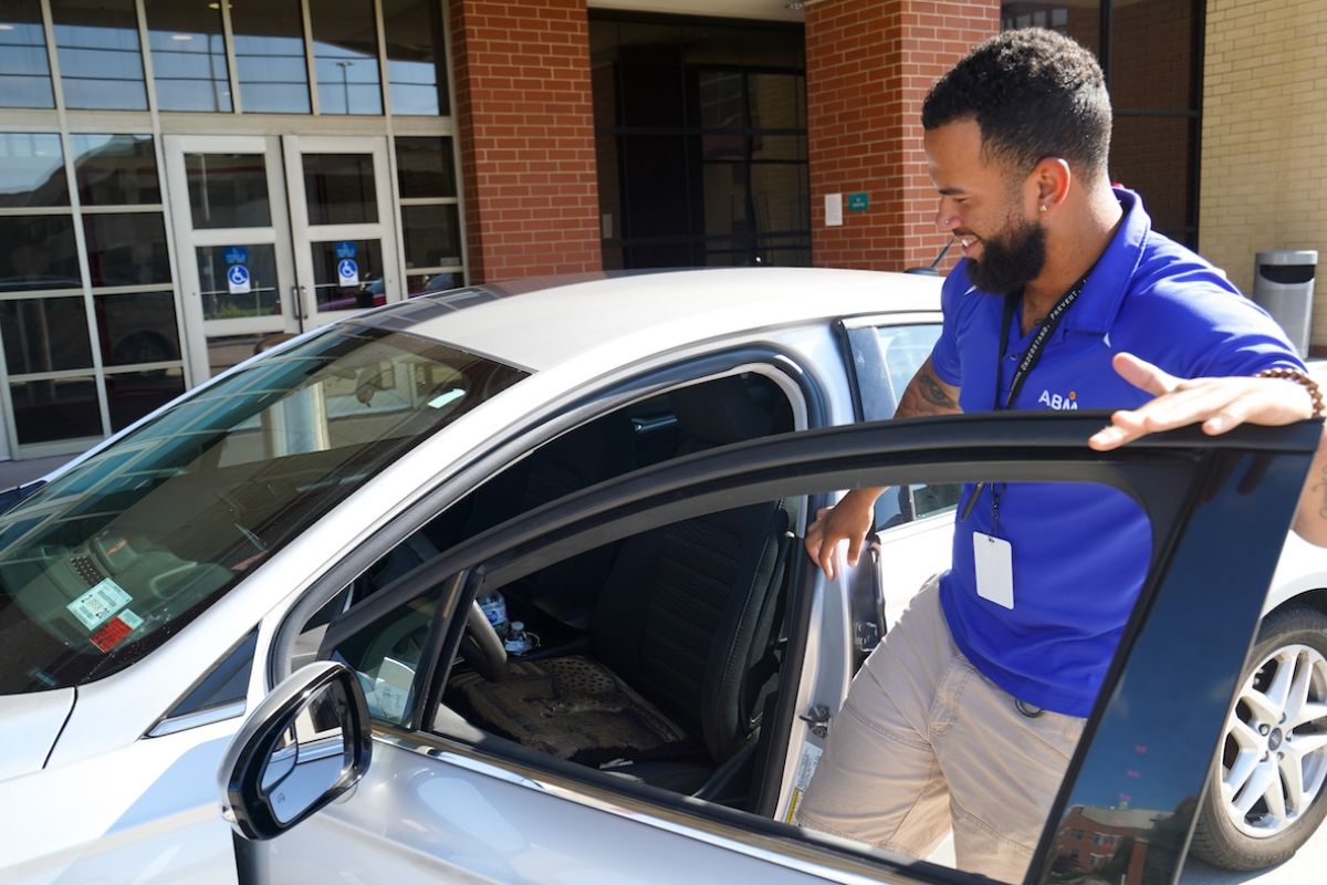 Roswell Park valet attendant gets into a silver car outside the main entrance
