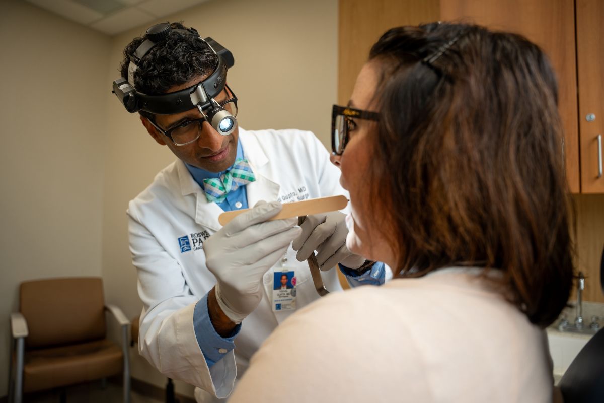Doctor looking inside the mouth of a patient