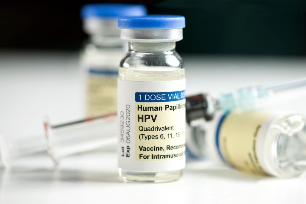 Small glass vials labeled HPV vaccine with a syringe