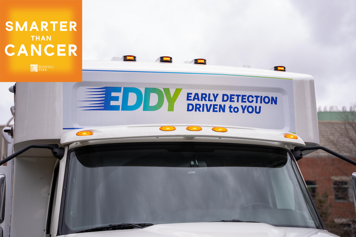 The front of EDDY (Early Detection Drive To You) van with the Smarter than Cancer podcast logo overlayed in the corner