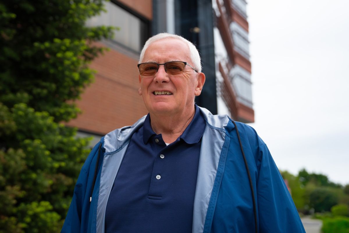 A man stands outside in sunglasses