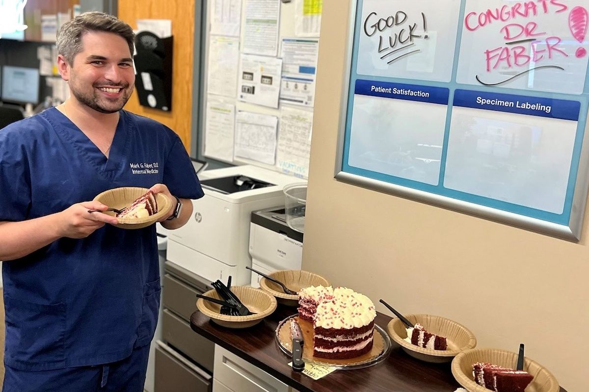 Man with a piece of cake for a farewell party
