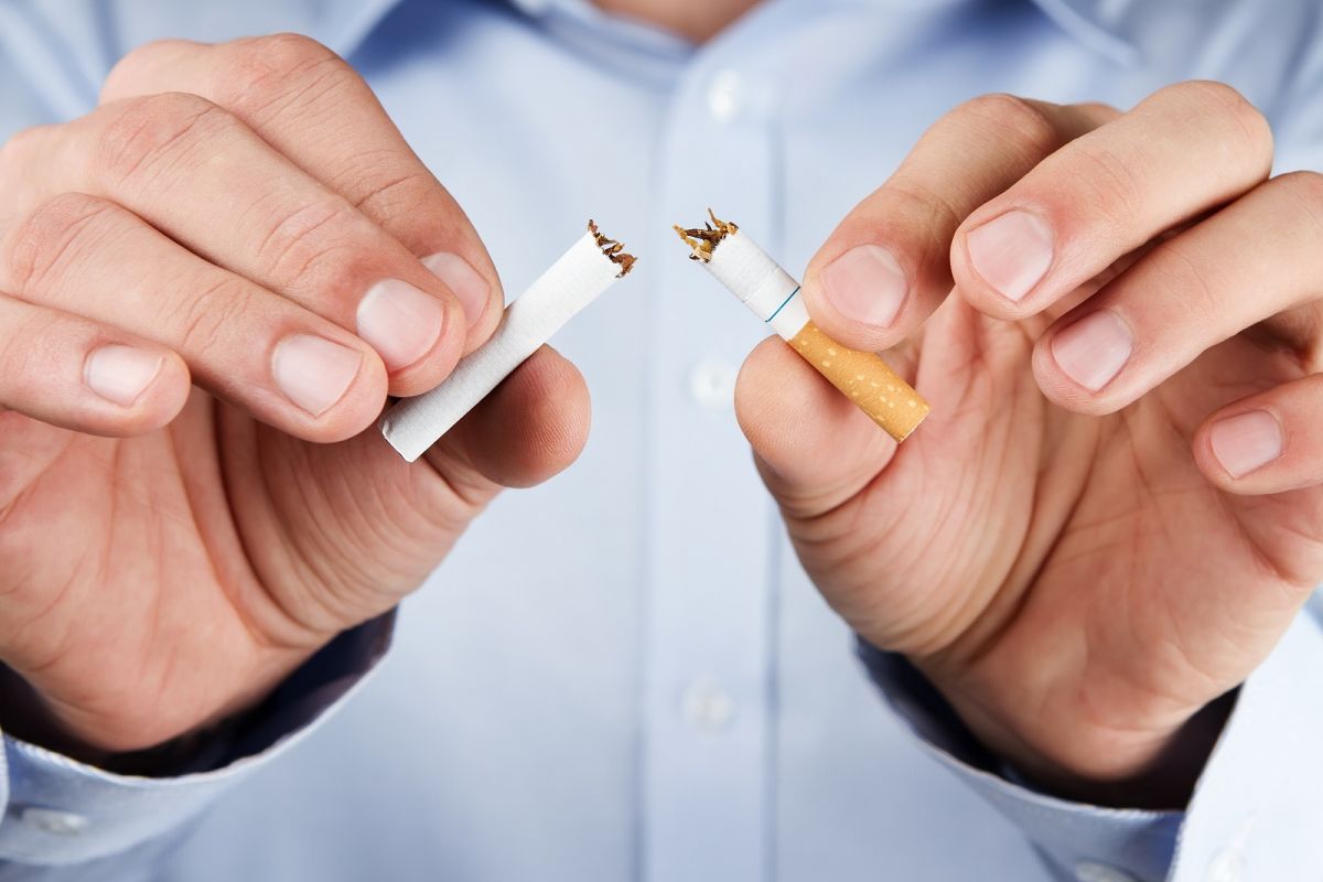 Close up of male hands holding cigarette broken in half