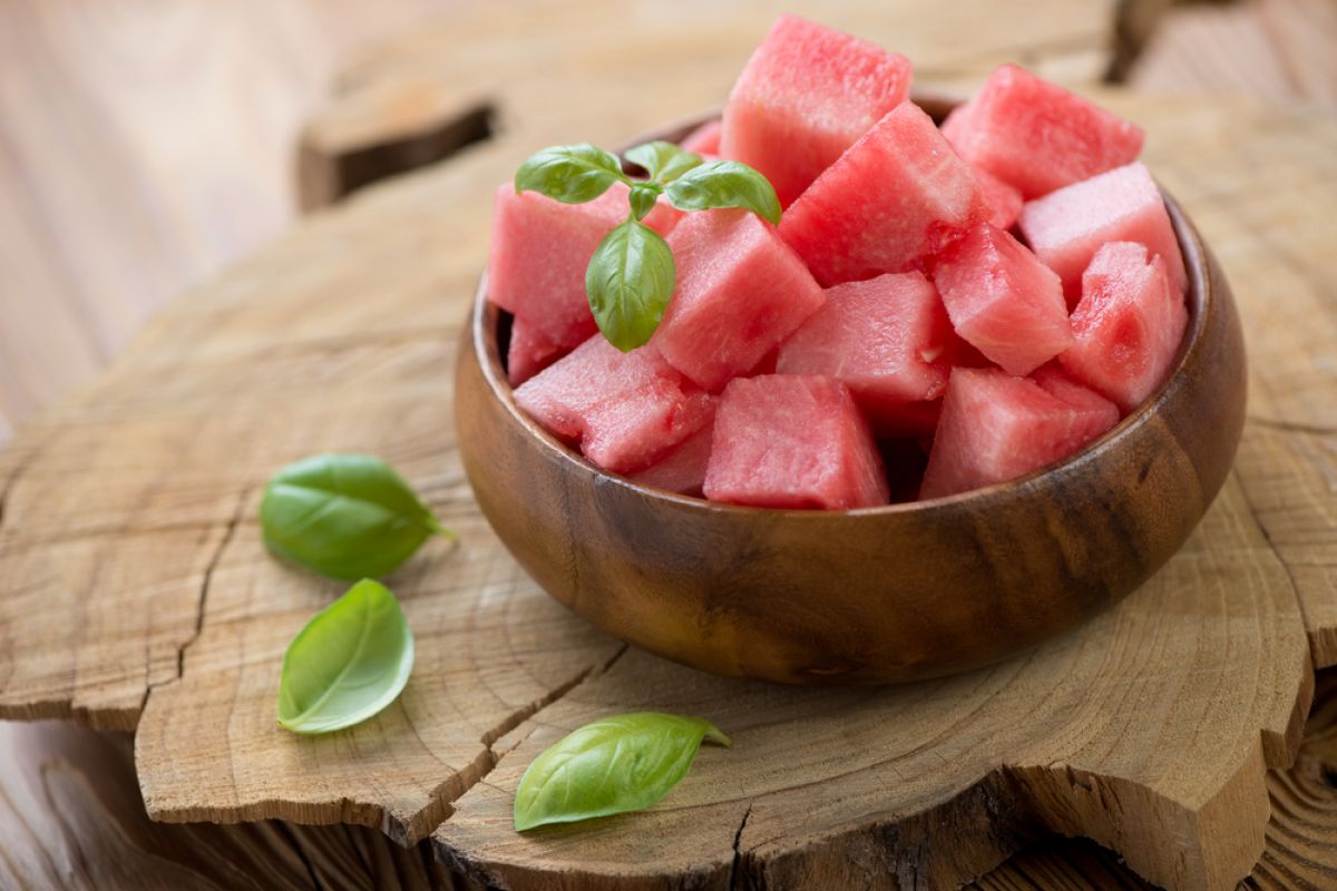 Diced watermelon in a bowl garnished with mint