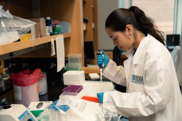 A high school student works in a lab as part of the Roswell Park High School Summer Research Program