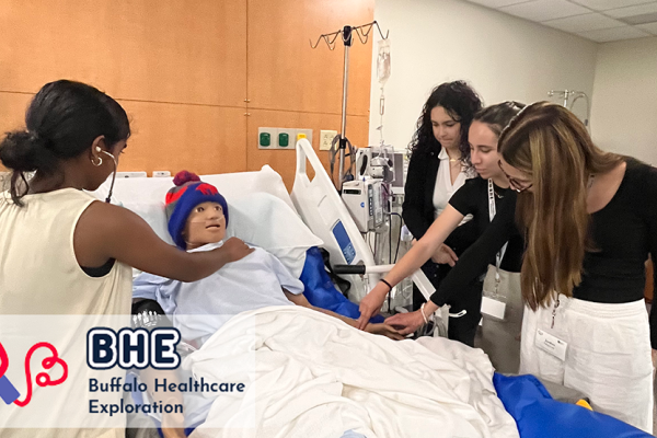 4 students in the Buffalo Health Exploration work on a mock patient in the Nursing Lab