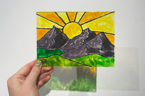 Stained glass painting of a sunset in the Art Heals Gallery for a guided class