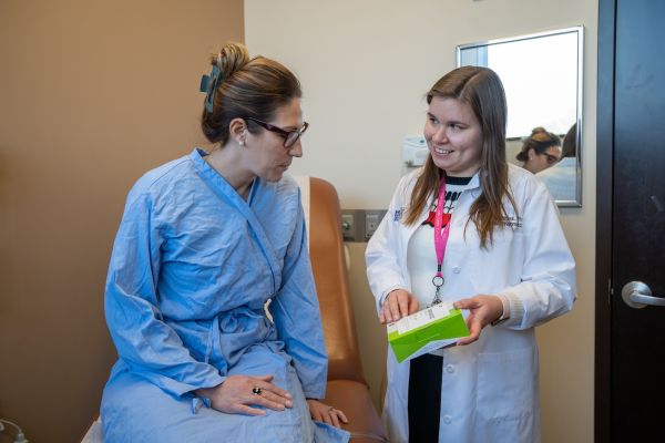 Pharmacists Christina Matthews meets with a female patient to discuss their chemotherapy drugs in clinic