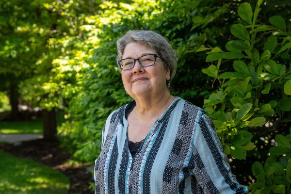 Patient Lynn Smith, treated for liver metastases with hepatic artery infusion, poses in Kaminski Park