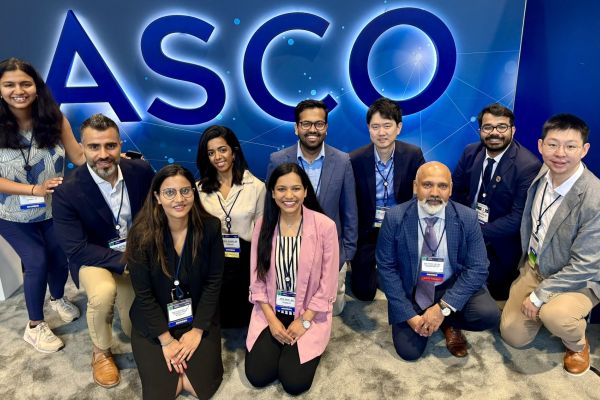 A group of staff, fellows, doctors and mentors pose at ASCO