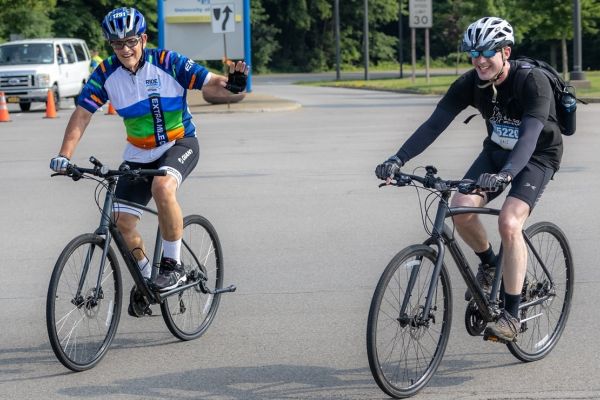 Paul Leo, left, and Dr. Jens Hillengass ride together during the Ride for Roswell.